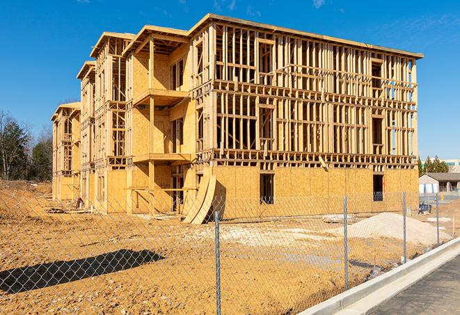 a temporary chain link fence locking away a building under renovation, serving as a security tool in Carlsbad CA